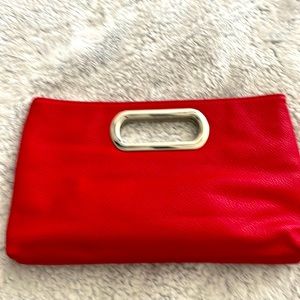 Brand new never worn red clutch bag with silver strap to wear as a crossbody.